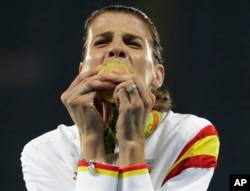 Spain's Ruth Beitia kisses her gold medal for the women's high jump during athletics competitions at the Summer Olympics inside Olympic stadium in Rio de Janeiro, Brazil, Aug. 20, 2016.