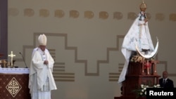 Pope Francis celebrates Mass next to a statue of the Virgin de la Puerta, at Huanchaco beach in Trujillo, Peru, Jan. 20, 2018. 