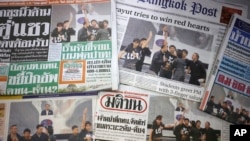 FILE - Front pages of Thai newspapers in Bangkok.