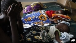 Unidetified mother watches over malari-stricken child, Siaya hospital in Western Kenya, Nov. 9, 2012.