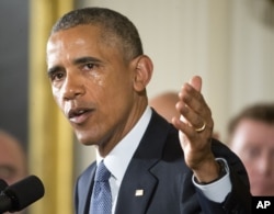 FILE - His cheek wet with tears, President Barack Obama recalls the 20 first-graders killed in 2012 at Sandy Hook Elementary School, while speaking in the East Room of the White House in Washington, Jan. 5, 2016.