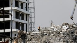 FILE: A rescue member works on the debris as search and rescue efforts continue at the site of a collapsed building in Ikoyi, Lagos, Nigeria Nov. 2, 2021.