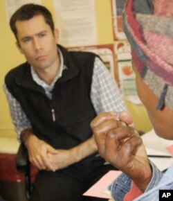 Zithulele Hospital’s chief doctor, Ben Gaunt, listens to an HIV-infected patient. He says allied health professionals aren’t getting the credit they deserve as South Africa battles HIV and AIDS