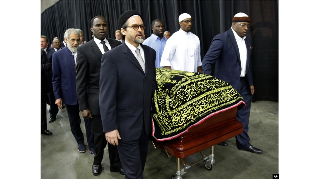 Muhammad Ali's casket is escorted by pallbearers for his Jenazah, a traditional Muslim service, at Freedom Hall in Louisville, Ky., June 9, 2016.