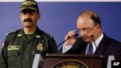 Colombian Defense Minister Luis Carlos Villegas, right, and national Police Chief Gen. Rodolfo Palomino appear before reporters in Bogota to discuss a police helicopter crash that killed 16 officers taking part in a manhunt, Aug. 4, 2015. 