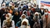 Orang-orang yang memakai masker pelindung berjalan melalui peron stasiun kereta api pada jam sibuk sore hari saat varian omicron terus menyebar, di tengah pandemi COVID-19, di Jakarta, 3 Januari 2022. (Foto: Reuters)