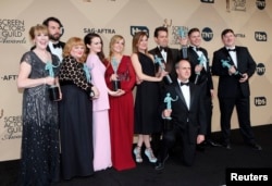 The cast of Downton Abbey, from left, Phyllis Logan, Tom Cullen, Lesley Nicol, Sophie McShera, Joanne Froggatt, Raquel Cassidy, Kevin Doyle,Tom Cullen, Allen Leech, and Jeremy Swift, hold their awards for Outstanding Performance by an Ensemble in a Drama Series during the 22nd Screen Actors Guild Awards in Los Angeles, California on Jan. 30, 2016.