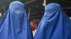 FILE - Burqa-clad women are pictured at a market in Kabul, Afghanistan, Dec. 20, 2021. 