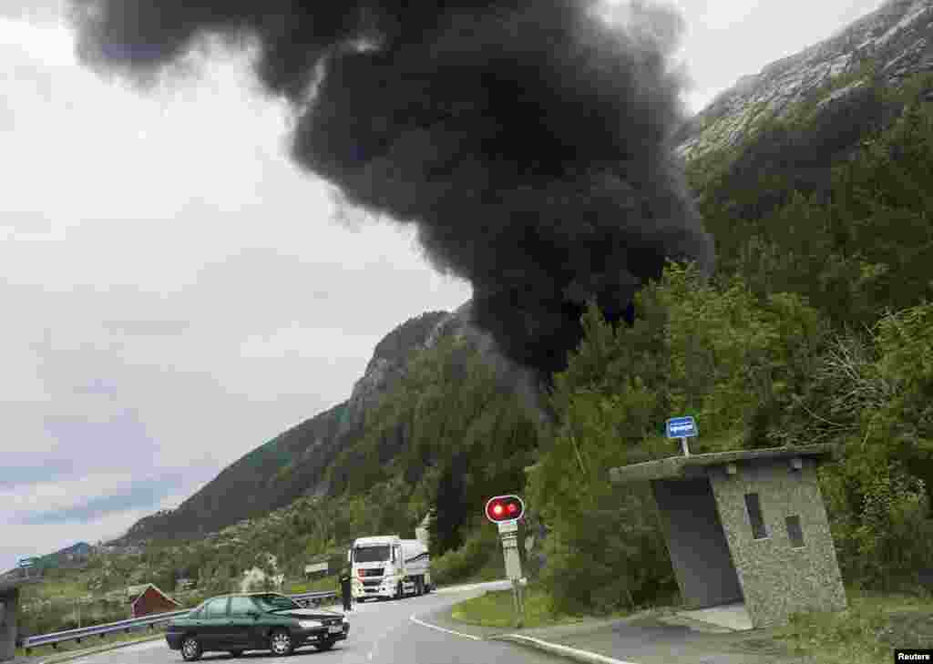 Smoke rises from the Skatestraum tunnel, after a gasoline trailer carrying around 16,000 liters of gasoline exploded inside the tunnel in Bremanger, Norway.
