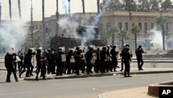Riot police fire tear gas towards supporters of the Muslim Brotherhood during a demonstration at Cairo University, Egypt, May 20, 2014.