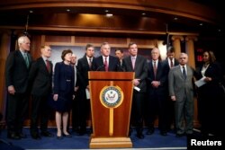 Chairman of the Senate Intelligence Committee Richard Burr (R-NC) stands with members of the committee as he speaks to the media about the committee's findings and recommendations on threats to election infrastructure on Capitol Hill in Washington, March 20, 2018.