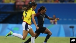 FILE - Colombia's Isabella Echeverri, left, and United States' Crystal Dunn go for the ball during a group G match of the women's Olympic football tournament between Colombia and United States at the Arena Amazonia stadium in Manaus, Brazil, Aug. 9, 2016.
