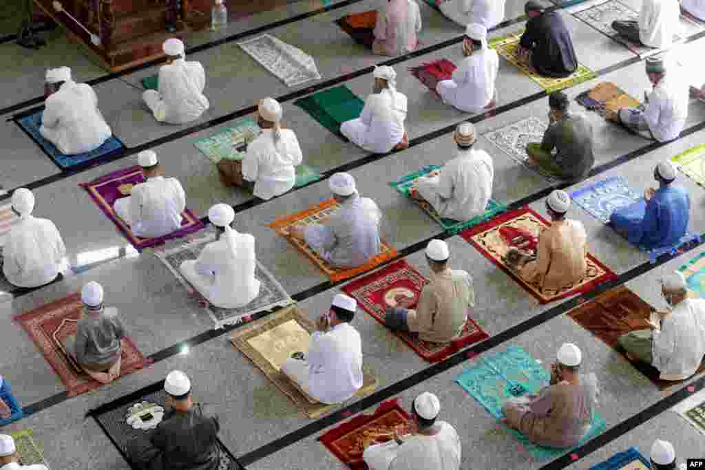 Muslim men practice social distancing as a preventive measure against the spread of the COVID-19 novel coronavirus as they take part in Friday prayers during the Islamic holy month of Ramadan at a mosque in Chana District in Songkla Province, Thailand.