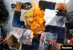 Protesters burn an effigy of U.S. President Donald Trump, who is attending the Association of Southeast Asian Nations (ASEAN) Summit and related meetings in Manila, Philippines, Nov. 13, 2017.