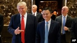 President-elect Donald Trump stands with Alibaba Executive Chairman Jack Ma as they walk to speak with reporters after a meeting at Trump Tower in New York, Jan. 9, 2017.