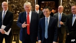 FILE - Donald Trump, who was then the U.S. president-elect, stands with Alibaba Chairman Jack Ma as they walk to speak with reporters after a meeting at Trump Tower in New York, Jan. 9, 2017.