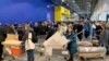 People wait in a line to pay for her purchases at the IKEA store on the outskirts of Moscow, Russia, March 3, 2022. 