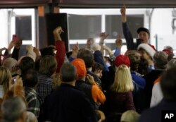 Donald Trump supporters point out a protester during a rally on Pearl Harbor Day at Patriots Point