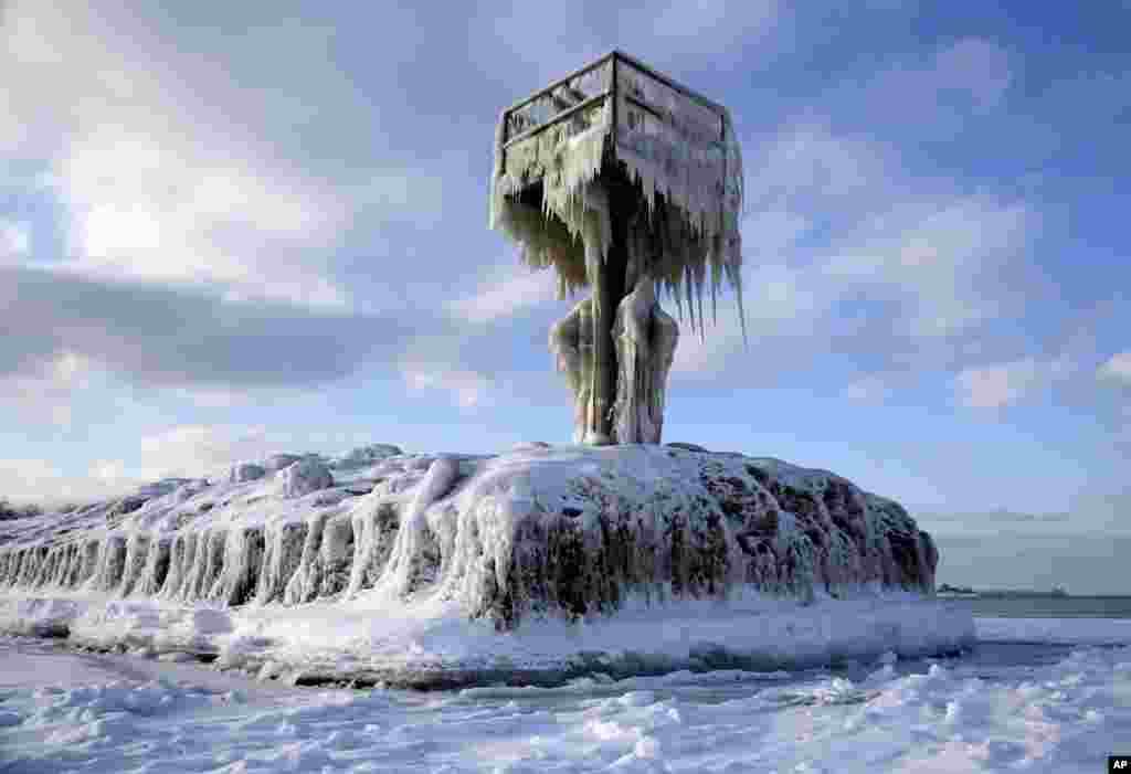 A harbor light on Lake Michigan at the 31st Street Harbor in Chicago, Illinois, is covered by snow and ice, March 1, 2015.