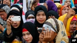 Filipino Muslims join a protest at the Philippine Congress, Feb. 3, 2016, at suburban Quezon city, northeast of Manila, Philippines. 