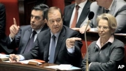 French PM Francois Fillon, left, with Parliamentary Relations Minister Patrick Ollier, centre, his partner Foreign Affairs Minister, Michele Alliot-Marie during the government questions at the French Parliament in Paris, February 9, 2011.