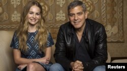 Cast members George Clooney and Britt Robertson pose for a portrait while promoting their upcoming movie "Tomorrowland" in Beverly Hills, California, May 8, 2015. 