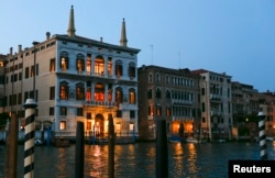 The entrance of the Aman hotel (L) on Venice's Grand Canal, where it is rumored U.S. Hollywood star George Clooney will celebrate his wedding with his fiancee Amal Alamuddin, is seen in Venice, Sept. 25, 2014.