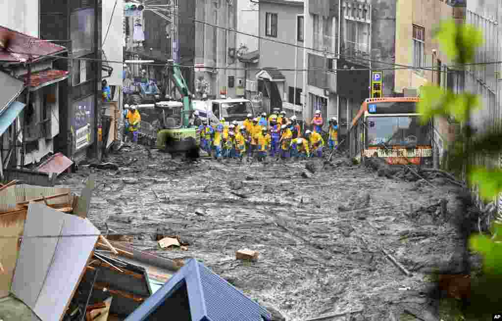 Rescuers conduct a search operation at the site of a mudslide in Atami, Shizuoka prefecture, southwest of Tokyo. (Credit: Kyodo News)