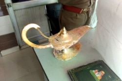 Genie usually live in lamps. But in this English expression, we say bottle. This photograph taken on October 29, 2020 shows a lamp which the owner claims had magic powers as described in the popular folk tale "Aladdin's lamp." It was allegedly sold for $93,000. Photo released by the Uttar Pradesh Police (UP Police).
