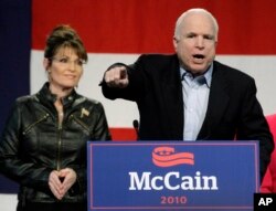 Sen. John McCain, R-Ariz., right, speaks to the crowd as Sarah Palin looks on at a campaign rally at the Pima County Fairgrounds in Tucson, Ariz. on Friday, March 26, 2010.