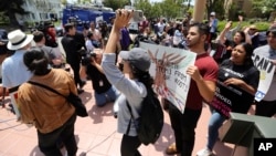 FILE - Supporters of the Deferred Action for Childhood Arrivals Act (DACA) and others demonstrate outside the U.S. District Court 9th Circuit in Pasadena, Calif., May 15, 2018. 