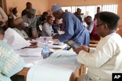 Electoral officials compile voting results at a collation center in Yola, in Nigeria, Feb. 24, 2019.