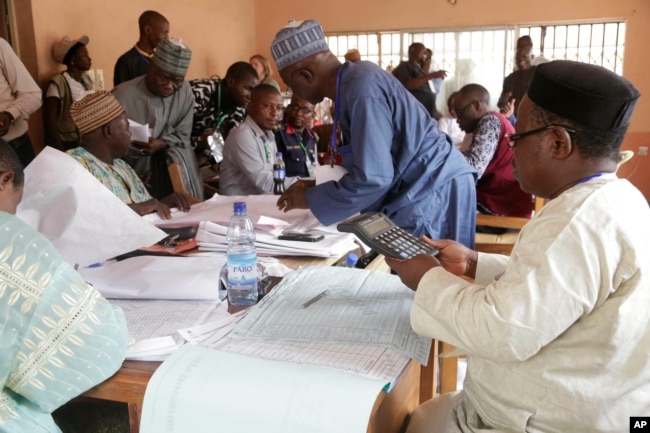 Electoral officials compile voting results at a collation center in Yola, in Nigeria, Feb. 24, 2019.