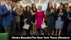 New York Times staff writers, 3rd L - R; Jodi Kantor, Megan Twohey, senior enterprise editor Rebecca Corbett and reporter Cara Buckley celebrate with colleagues in the newsroom after the team they led won the 2018 Pulitzer Prize for Public Service in New 