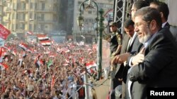 FILE - Egypt's Islamist President-elect Mohamed Mursi looks at the crowd awaiting his speech in Cairo's Tahrir Square, June 29, 2012. 