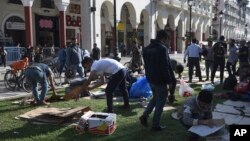 Migrants clear the Aristotelous Square in the northern Greek city of Thessaloniki, Oct. 8, 2018. Several hundred asylum-seekers camped outside a police station in Greece's second-largest city, lining up to be arrested and formally processed, as a surge in illegal migration in northern Greece has overwhelmed authorities.