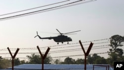 A helicopter carrying an advisory commission lands near newly-built repatriation camps prepared for Rohingya refugees expected to be returning from Bangladesh, Jan. 24, 2018, in Taungpyo, Myanmar.