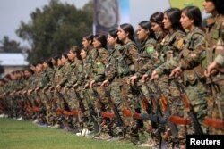 Kurdish female fighters of the Women's Protection Unit (YPJ) take part in a military parade as they celebrate victory over the Islamic state, in Qamishli, Syria, March 28, 2019.
