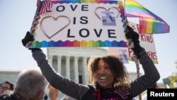 FILE - Ikeita Cantu holds a sign supporting same sex marriage in front of the Supreme Court before the court hears arguments about gay marriage in Washington, April 28, 2015.