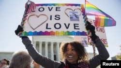 Ikeita Cantu holds a sign supporting same sex marriage in front of the Supreme Court before the court hears arguments about gay marriage in Washington, April 28, 2015.