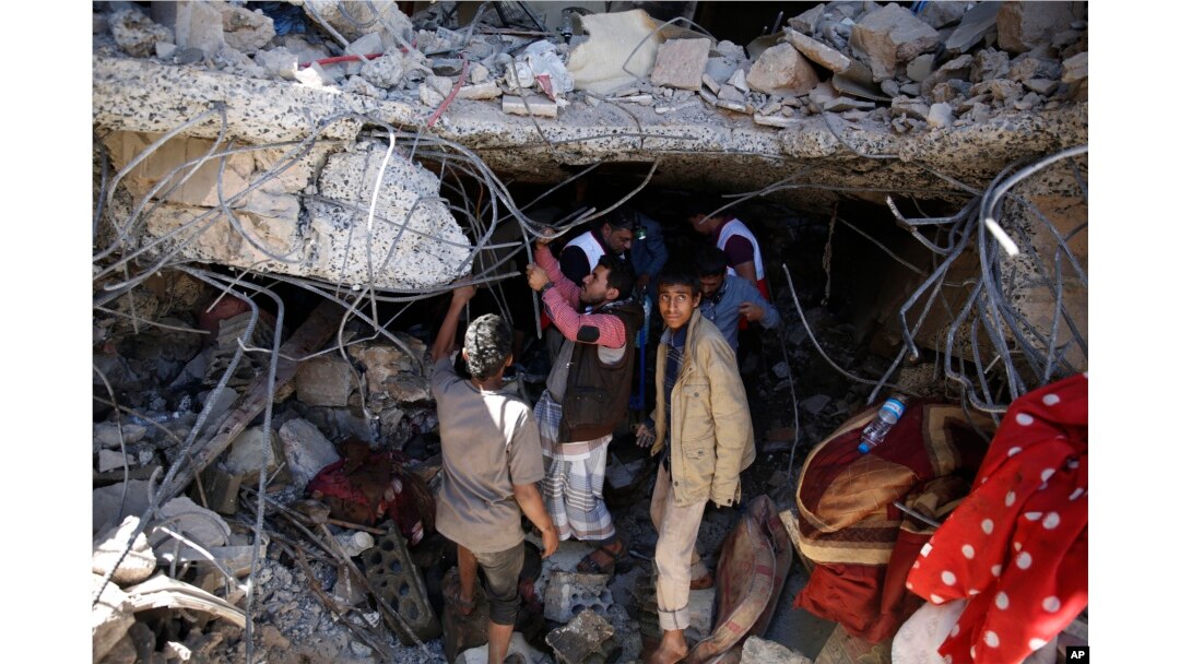 FILE - People search for survivors under the rubble of a house destroyed by Saudi-led airstrikes that killed a TV director, his wife, and three children in Sanaa, Yemen, Wednesday, Feb. 10, 2016.