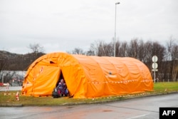 A girl enters a the temporary reception center for refugees at Storskog border station near Kirkenes in northern Norway at the Norway-Russia border, on Oct. 13, 2015.