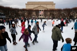 People skate on the National Gallery of Art Sculpture Garden Ice Rink, Dec. 27, 2018, as a partial government shutdown continues in Washington. The museum and the skate rink will be closed to the public after Jan. 2 as a result of the shutdown if it continues.
