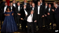 Peter Farrelly, center, and the cast and crew of "Green Book" accept the award for best picture at the Oscars on Sunday, Feb. 24, 2019, at the Dolby Theatre in Los Angeles.
