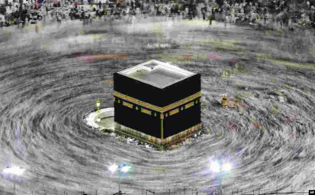 In this picture taken with slow shutter speed, Muslim pilgrims circumambulate the Kaaba, the cubic building at the Grand Mosque, durning the hajj pilgrimage in the Muslim holy city of Mecca, Saudi Arabia, Aug. 13, 2019.
