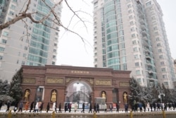 Workers from the restaurant industry line up for their covid tests in Beijing, China, Jan. 22, 2022. Chinese authorities have called on the public not to travel during the Lunar New Year.