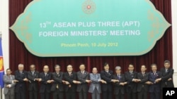 ASEAN countries' foreign ministers join their hands during a photo session at the 45th Association of Southeast Asian Nations (ASEAN) Foreign Ministers' Plus three Meeting in Phnom Penh, Cambodia, Tuesday, July 10, 2012. 