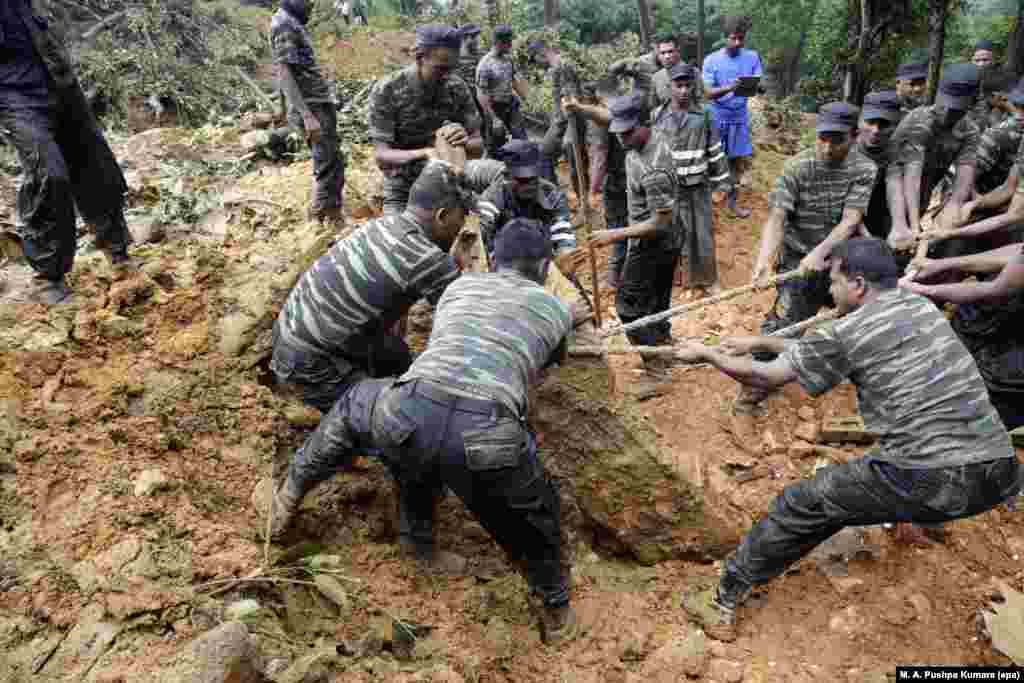 Sri Lanka Armed Forces personnel engage in a rescue operation at the landslide area where 16 people have been reported missing at Kalupahanawatte in Bulathkohupitiya, 97 kms from the capital, Colombo.