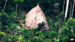 This 2017 photo released by the National Indian Foundation (FUNAI) shows a "maloca," or long house, in Vale do Javari, Amazonas state, Brazil. (FUNAI via AP)