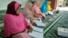 Perempuan dengan disabilitas sensorik di Kota Medan, Sumatra Utara, sedang membaca Alquran braille. (Courtesy: Persatuan Tunanetra Indonesia atau Pertuni)